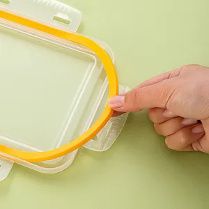Clear plastic bento lunch box with removable yellow silicone sealing ring for food storage.