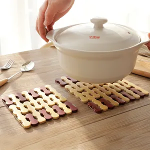Foldable wooden hot pot mat heat resistant trivet for kitchen and dining table.