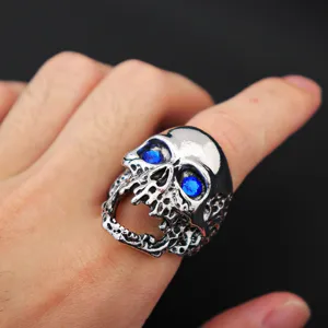 Detailed close-up shot of a punk oversized skull ring with brilliant blue zircon eyes.