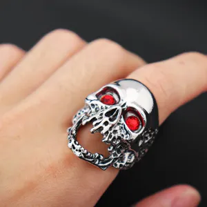 Detail shot of punk alloy oversized skull ring with red zircon stones for men style.