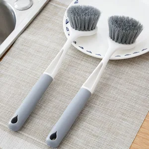 Long handled cleaning brush for kitchen dishes and pots, non-slip grey handle with durable bristles.