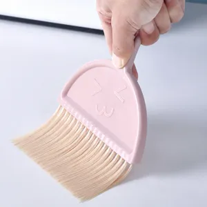 Mini desktop broom and dustpan set, cute pink plastic cleaning brush for office and home desk.