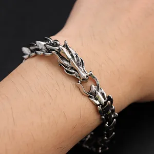 Close-up detail shot of vintage punk dragon head metal bracelet, gothic hip-hop wrist jewelry.