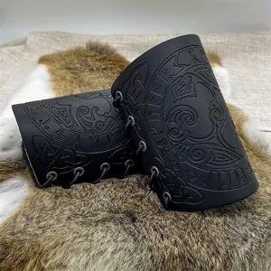 Detailed view of black embossed Viking leather bracers with Nordic rune patterns for COS.
