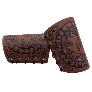 Detail view of Viking medieval leather bracers with runic embossed patterns and black lacing.