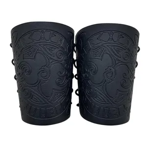 Detailed view of black embossed leather bracers with Norse Viking raven and runic motifs for medieval cosplay.