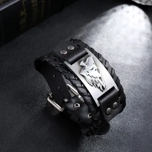 Close-up detail of retro Viking wolf head braided leather bracelet for men with metal plate.