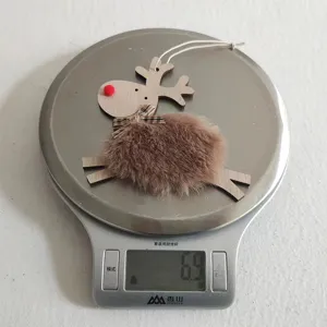 Close-up detail shot of a cute wooden and plush reindeer Christmas tree hanging pendant ornament.