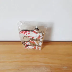 Wooden Christmas door corner decoration detail view featuring Santa and snowman cartoon pendants.