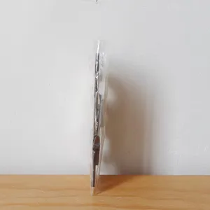 Wooden Christmas door frame decoration detail view, packaged in clear protective plastic.