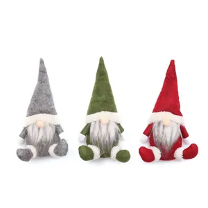 Close-up details of Nordic Christmas gnome plush dolls featuring grey, green and red festive colors.