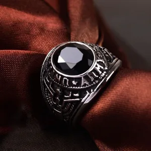 Vintage military style alloy ring with black gemstone and eagle engraving detail closeup.