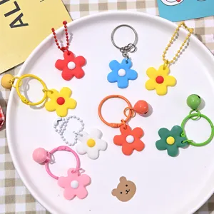 Gedetailleerd overzicht van gekleurde geëmailleerde bloemensleutelhangers, DIY-accessoires.