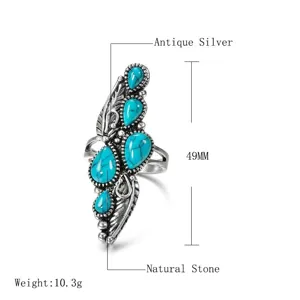 Bohemian ethnic style feather alloy ring with natural turquoise stone and antique silver finish.