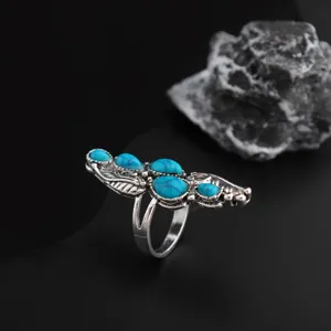 Close-up detail of bohemian turquoise feather ring alloy ring intricate carving design