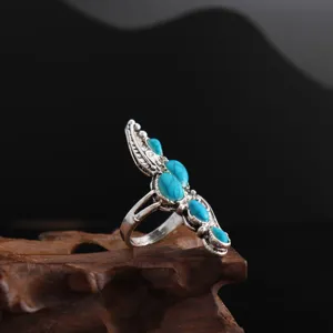 Bohemian turquoise feather ring detail shot, vintage silver alloy boho jewelry piece.