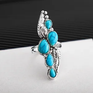 Detailed close-up of a bohemian vintage silver-plated turquoise feather ring statement.