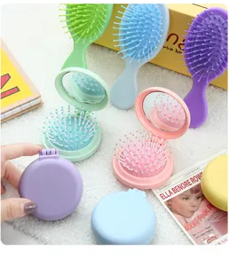 Brosse à cheveux pliante portable avec miroir, mini peigne de massage mignon pour femmes.