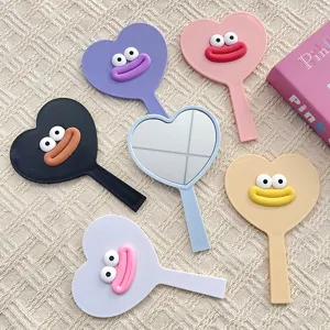 Cute heart-shaped hand mirror with funny 3D lips and eyes, colorful makeup mirror.