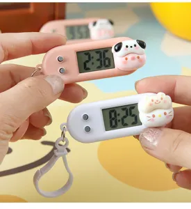Mini cartoon electronic watch detail showing portable keychain design and clear LCD display screen.