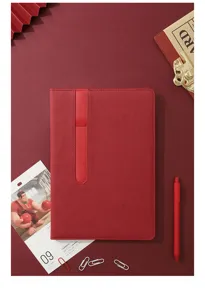 Detail shot of the red business notebook showing the vertical pen loop and textured PU cover.