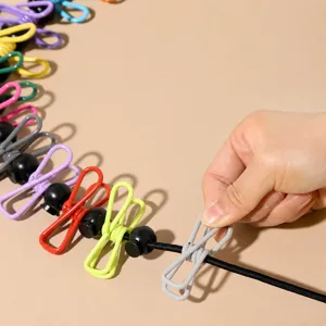 Portable travel clothesline with colorful clips, elastic outdoor laundry rope for home.