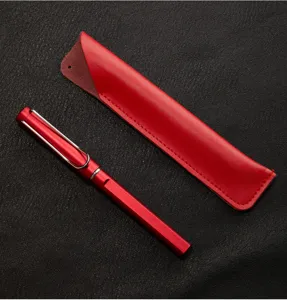 Red metal fountain pen and leather sleeve detail, vintage business style writing tool closeup view.