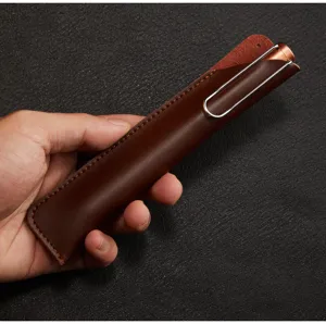 Handmade brown leather pen sleeve detail showing fine vintage style and neat stitching.