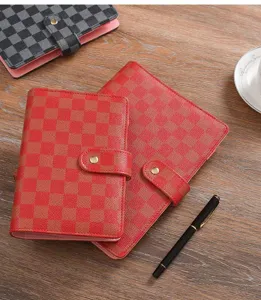 Cuaderno de anillas de cuero con patrón de cuadros clásico y cierre de botón metálico a presión.