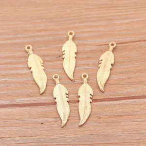 Detailed view of small gold feather metal charms, ideal for DIY bracelets and necklaces.
