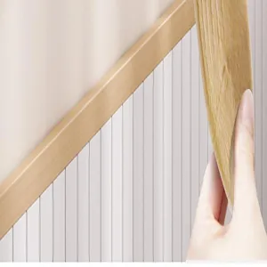 Self-adhesive wood grain wall trim detail showing the peel and stick adhesive backing feature.