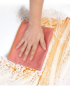 Close-up detail shot of a cleaning cloth wiping stains, showing strong water absorption.