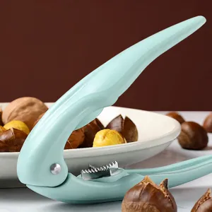 Green manual chestnut opener nutcracker tool with serrated blade for easy peeling nuts.