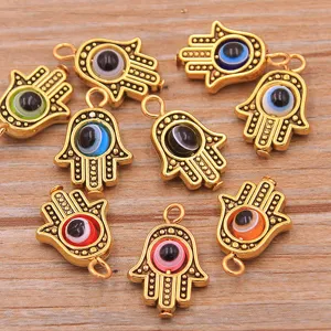 Detailed shot of Hamsa hand evil eye metal charms, DIY zinc alloy jewelry pendants for necklaces.