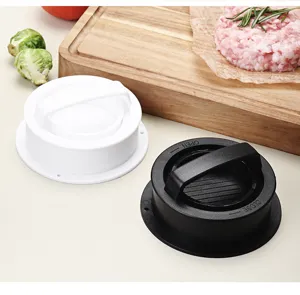 Close up view of plastic burger press mold with handle for kitchen cooking tools.