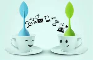 Creative leaf silicone tea infuser with cute smile ceramic teacup set for kitchen use.