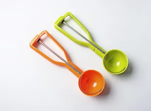 Detail shot of ergonomic plastic ice cream scoop with spring trigger mechanism in vibrant colors.
