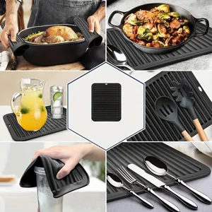 Versatile black silicone dish drying mat, heat resistant kitchen counter pad for hot pots.