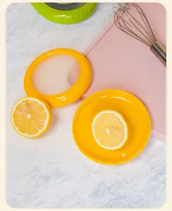 Silicone lemon saver cover for fridge, elastic food storage seal lid for cut fruit halves.