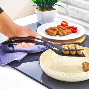 Detailed view of the 2-in-1 kitchen spatula and tongs, ideal for flipping and gripping food.