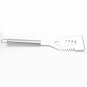 Stainless steel grill spatula detail showing multi-functional slots, serrated edge, and hanging ring.