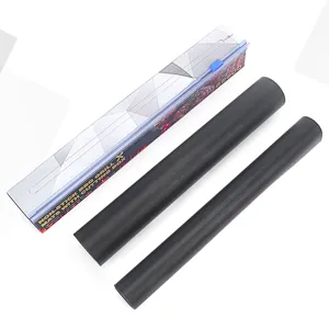 Detail view of black non-stick BBQ grill mat rolls with convenient sliding cutter storage box.