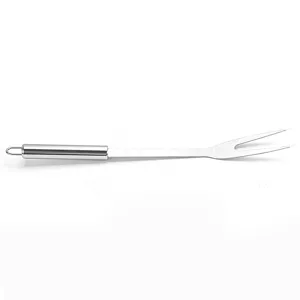 Stainless steel barbecue fork detail, durable metal grill tool for outdoor cooking.