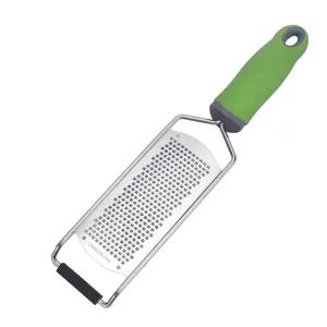 Stainless steel cheese grater and lemon zester with green ergonomic handle for kitchen cooking.