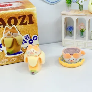 Cute flocked cat blind box figurine with banana and tea cup design for home decor desk.