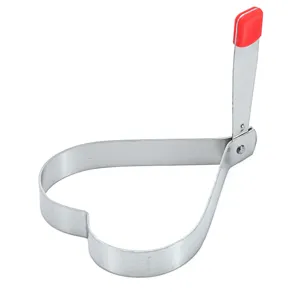 Detailed view of heart shaped stainless steel fried egg ring mold with red handle.