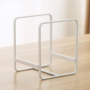 Detail view of the minimalist white metal storage rack showcasing clean lines and durable build.