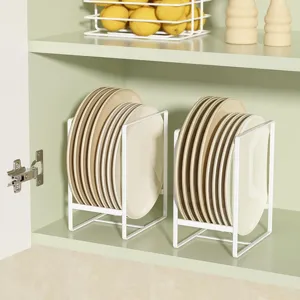 Close-up of white iron plate storage rack inside the kitchen cabinet organizer.