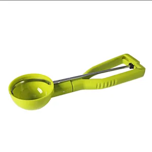 Multi-functional semi-automatic ice cream scoop with green plastic handle and metal balling tip.