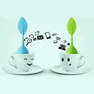 Creative leaf shape silicone tea infuser set with cute smiley cups for brewing loose leaf tea.